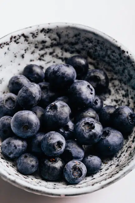 Fresh blueberries in a speckled bowl