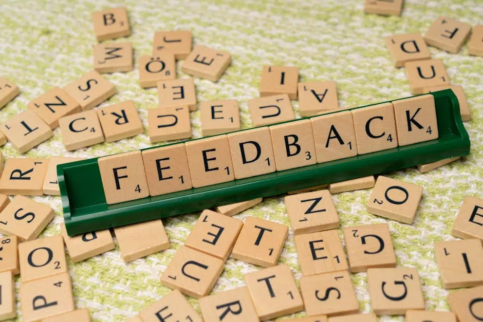Scrabble tiles spell 'feedback' on green rack.
