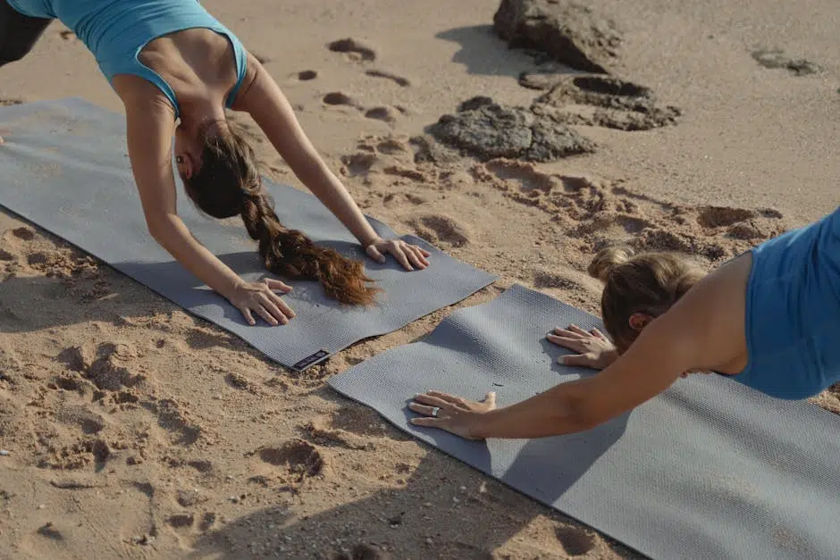 Women doing yoga on the beach.