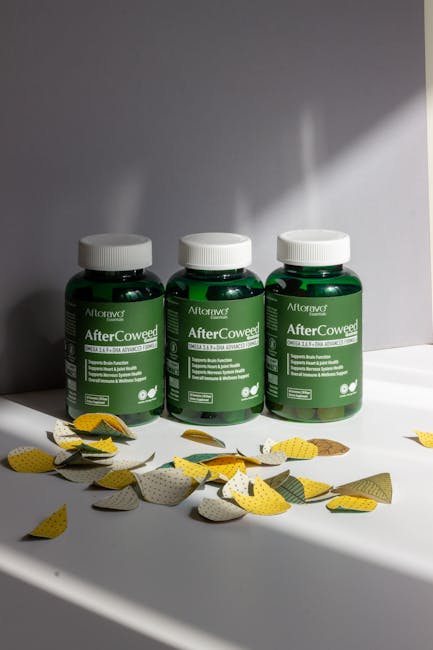 Three AfterCowged bottles with leaves on table.
