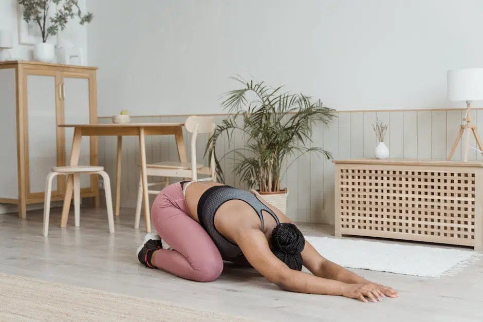 Person doing yoga child's pose at home.